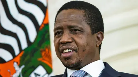 Close-up of Edgar Chagwa Lungu, former President of Zambia, pictured on 20 November 2015, in a suit with a white-collar shirt and grey-blue and pink patterned tie