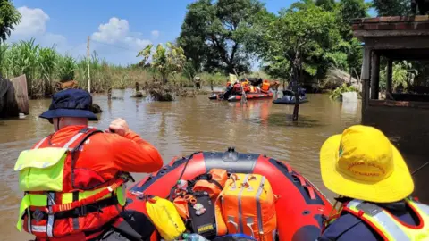 Firefighters in a red RIB rescue boat