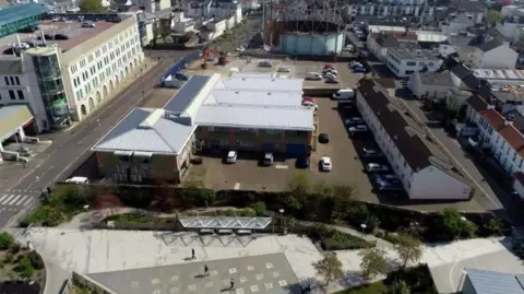 The photo shows various buildings and gas works on the Gas Place site. 