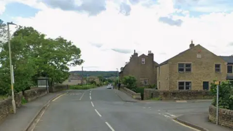 An empty T-junction. A bus stop and other street furniture can be seen. 