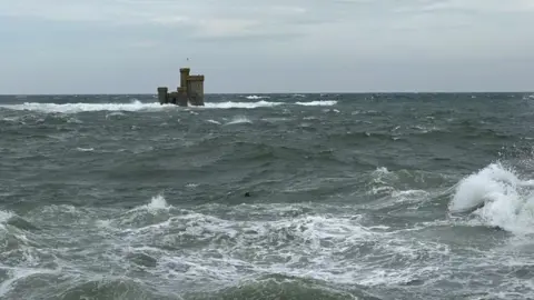 Choppy seas around the Tower of Refuge, which is a small castle-like stone structure, in Douglas Bay.