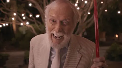 Parlophone Records Dick Van Dyke holds a candy-cane umbrella, recreating a scene from Mary Poppins in the video for Coldplay's All My Love