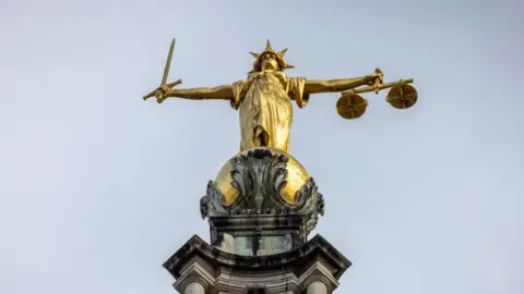 Getty Images A gold statue of Lady Justice on top of the central criminal court in London, United Kingdom.