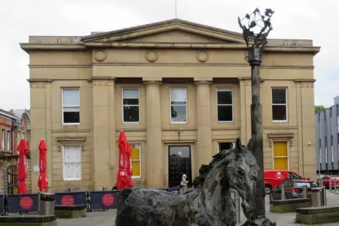Gerald England/Geograph Bexley Square image has the former town hall in the back ground and a horse sculpture in the foreground.
