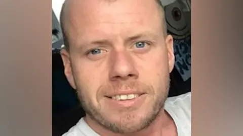 Police Scotland Police handout photo of a man with stubble with a slight smile