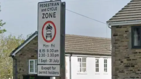 A sign restricting vehicles on a street in Bradford
