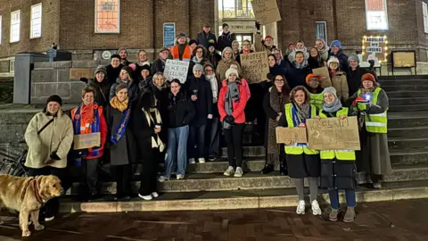 Lauren Brook Dozens of people gathered on Tunbridge Wells town hall steps, holding women's safety banners. 