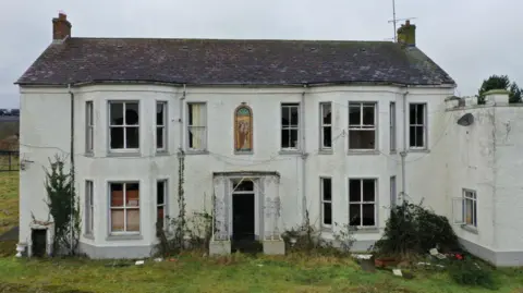 Getty Images Marianvale in Newry, it is a white derelict building