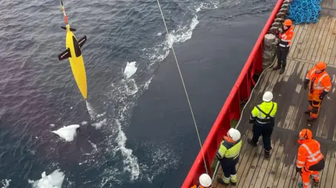 Carol Robinson/UEA A sea glider being winched from the sea by a team on board the RRS Sir David Attenborough