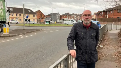 BBC Leigh Redman standing near the roundabout 