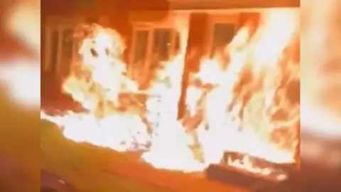 Sourced Aggressive frames emerging from a house.