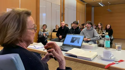 Eva Umlauf, a survivor, speaking to students at Dachau