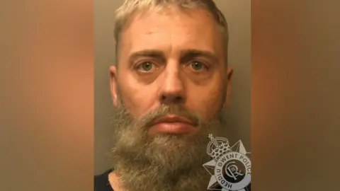 Gwent Police Christopher Scrivens mugshot. He has short hair and a beard