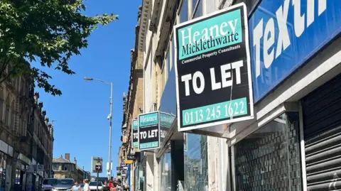 Adam Laver/BBC A series of empty shops with 'to let' signs above the windows