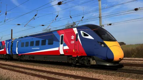 A view of a train in a mock up livery for GBR, showing light and dark blues, red, and white.