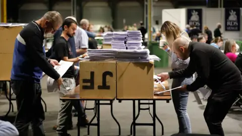 PA People count votes at the Royal Dublin Society during the counting of votes for the European elections