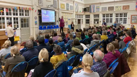 People sitting watching a presentation at the Safe Screens event at Fishergate Primary School