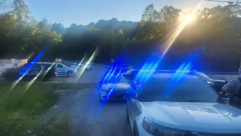 Laurel County Sheriff's Office A number of police cars visible near to where the shooting happened. They have blue lights, which are slightly blurred in the image. 