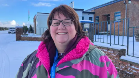 A woman in a camo dry robe type coat