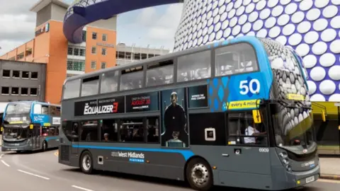 National Express West Midlands A bus drives past the Selfridges Bull Ring Shopping Centre