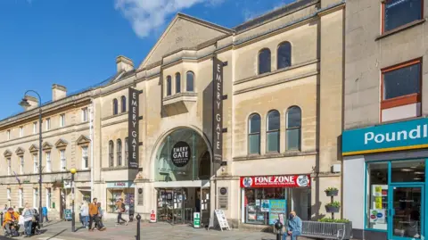 Acorn Property Group Front of the shopping centre from the street under a blue sky