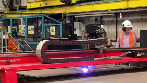 A worker operates machinery.