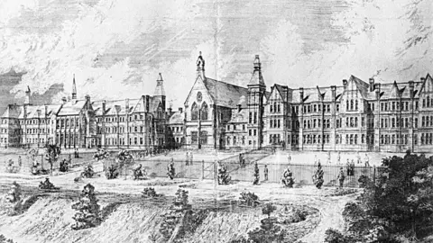 A black and white drawing of the asylum shortly after opening, showing a large, three storey Victorian building with fenced in exercise yards in front