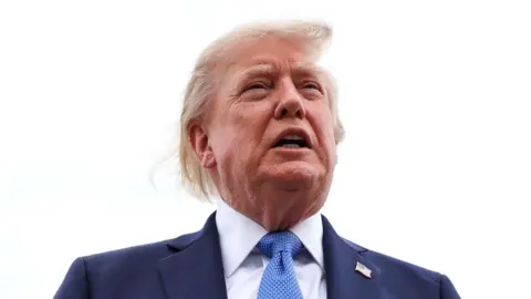 President Donald Trump speaks to reporters before boarding Air Force One.