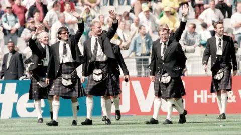 SNS Scotland squad at 1998 World Cup walking onto the pitch wearing kilts.