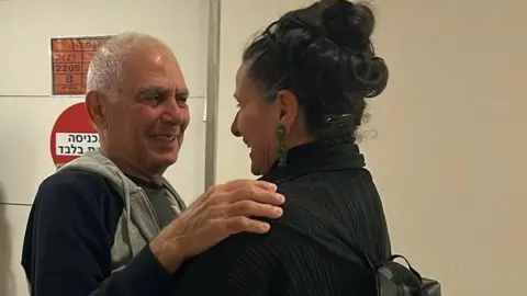 Evat Michikawa, Jadi Musa, embraces his niece in an Israeli hospital