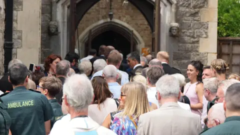 Eddie Mitchell A crowd of people walking into a church