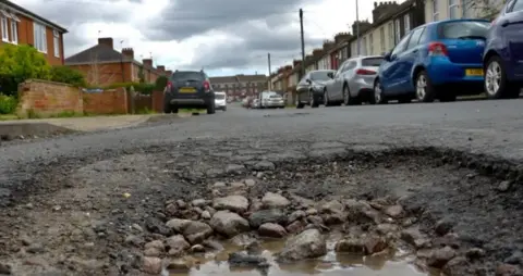 Jamie Niblock/BBC Close up of a pothole on street 