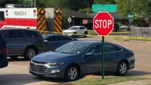 Cars and a police tape at the scene of a shooting in Louisiana