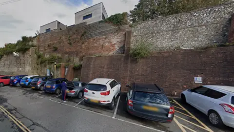 A Google street image of the car park with the wall in the background