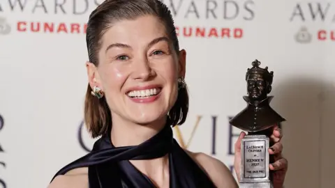 PA Rosamund Pike with her best actress award for Inter Alia at the Olivier Awards in April
