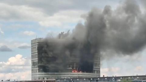 Smoke and flames billow from an office block near Moscow.
