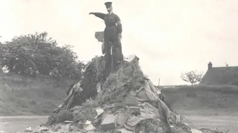 Essex Police A black and white photo shows an unlit bonfire with and effigy of Hitler at the top.