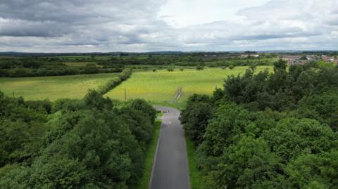 The existing view of the road into Rainton Meadows, showing the land at risk from development in distance.