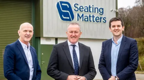 Pictured with Economy Minister Conor Murphy are George McKinney, Invest NI (left) and Martin Tierney, Seating Matters (right).