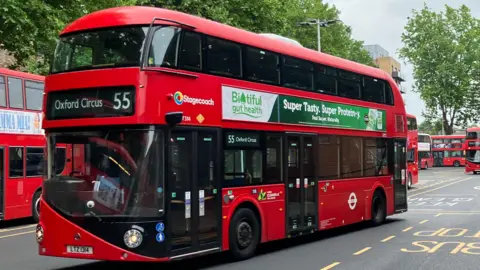 BBC/Harry Low 55 bus to Oxford Circus in bus depot with other red buses in the background