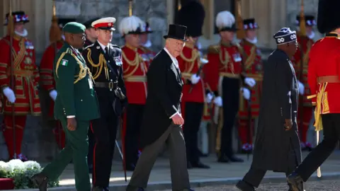 Reuters King Charles and President Tinubu and other uniformed figures outside Windsor Castle