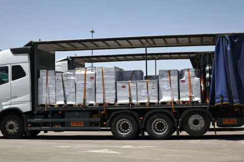 A truck carrying aid waits to enter the Gaza Strip at the Kerem Shalom crossing, southern Israel
