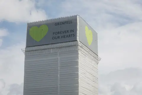 Getty Images The covered remains of the Grenfell high-rise, connected  the archetypal  day  of the operation    artifact  disaster