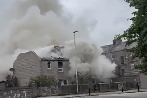 Fubar News Smoke billowing from a house on fire.