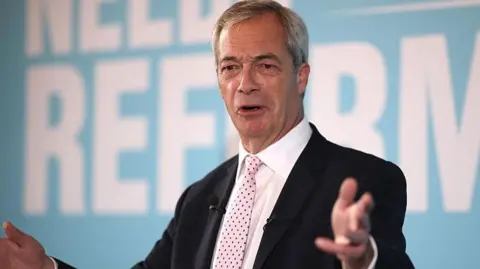 A photograph of Nigel Farage wearing a black suit and a pink tie. He is standing in front of a blue background and the words 'NEEDS REFORM' can be seen. 