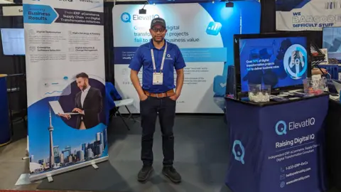 Sam Gupta Sam Gupta at a booth promoting ElevatIQ