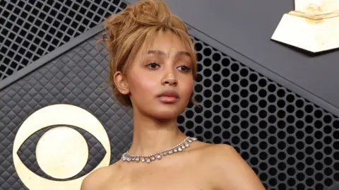 PinkPantheress poses on the red carpet during a premiere ceremony.