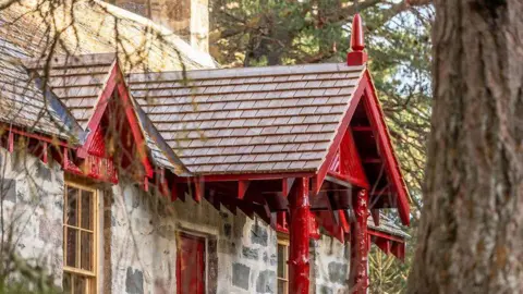 National Trust for Scotland A close up of a covered porch over the door of the cottage.