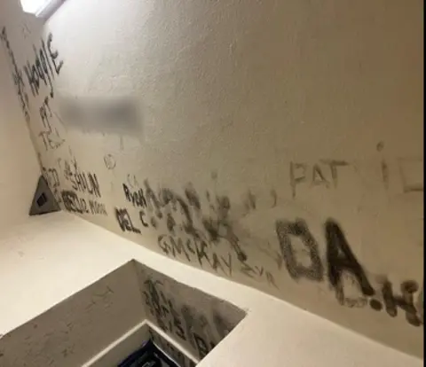 HMIPS Graffiti covering the walls of a cell in a court custody unit