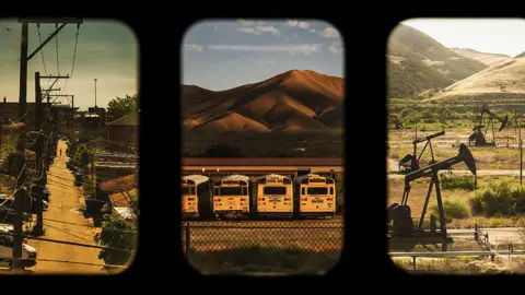 Katie Edwards A triptych of images taken from a train window. Left to right: An alley in Chicago, school buses in front of mountains and a beam pump extracting oil from an inland well.